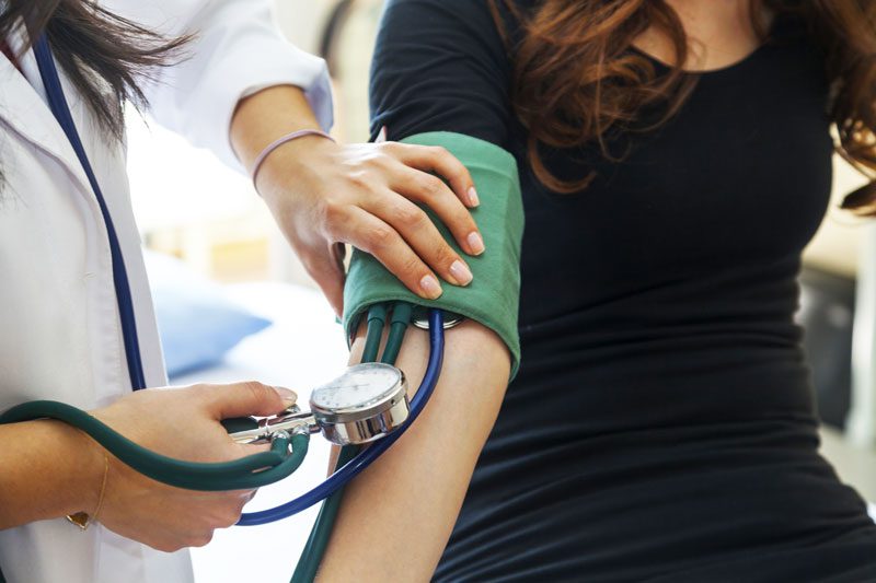 woman having blood pressure taken - detox centers in Kansas