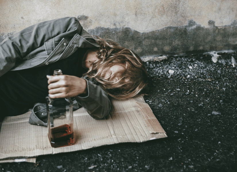 Homeless woman lay down on the ground holding alcohol - Help